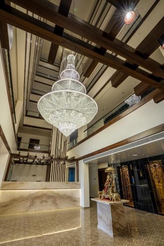 a large chandelier hanging from the ceiling of a store at Mastiff Grand The Sia Palace Suites & Banquets, Khopoli, Near Imagica in Khopoli