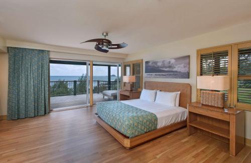 a bedroom with a bed and a balcony at Hana-Maui Resort, a Destination by Hyatt Residence in Hana