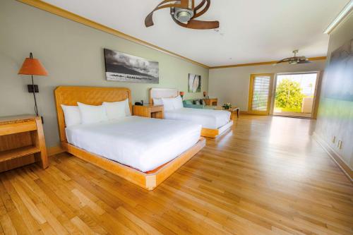 a bedroom with two beds and a wooden floor at Hana-Maui Resort, a Destination by Hyatt Residence in Hana