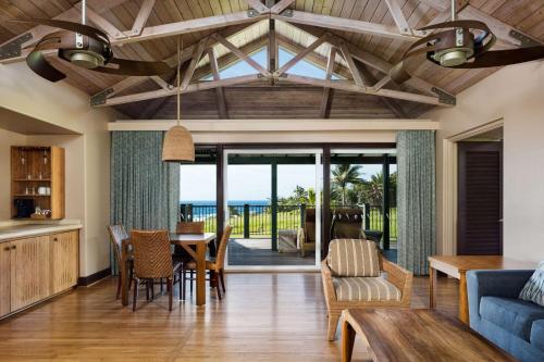 a living room with a table and chairs and the ocean at Hana-Maui Resort, a Destination by Hyatt Residence in Hana