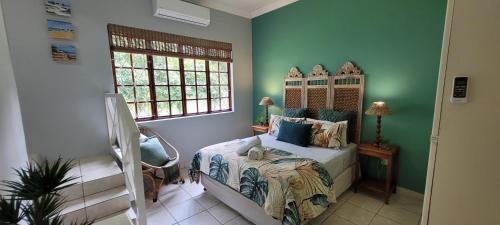 a bedroom with a bed and a window at 3 Lagoon Getaways in Southbroom