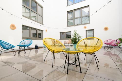 a group of chairs and tables in a room at Smart & Stay Aparthotel Saarbrücken Süd - Self-Check-In - Free Parking in Saarbrücken