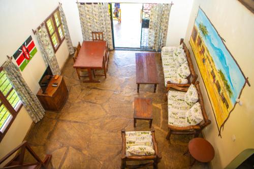 an overhead view of a living room with chairs and a table at Oasis Diani Beach Villas in Diani Beach