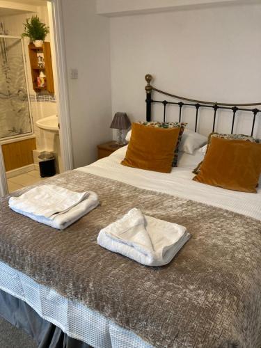 a bedroom with a bed with two towels on it at The Granary at Bissick Old Mill in Truro