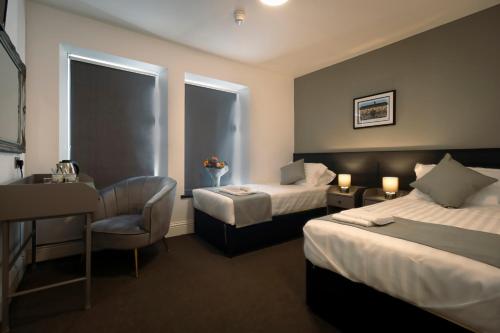 Ένα ή περισσότερα κρεβάτια σε δωμάτιο στο The Friendship Hotel