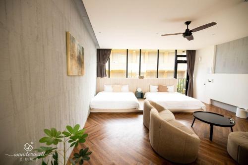a living room with a bed and a couch at Wonderwall in Wujie