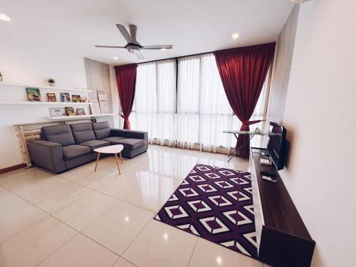 a living room with a couch and a tv at Connected train 3 Bedrooms - ABOVE KLGATEWAY MALL 14 in Kuala Lumpur