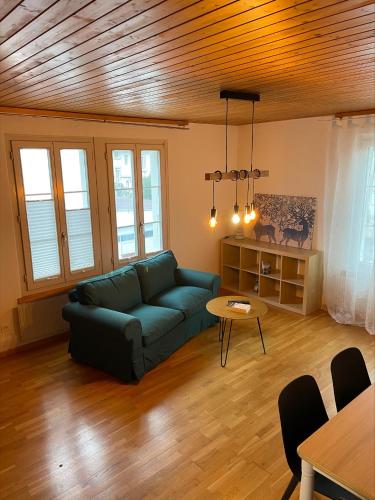 a living room with a couch and a table at Interlaken Apartments in Interlaken