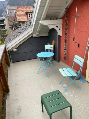 a patio with a table and chairs on a balcony at Interlaken Apartments in Interlaken