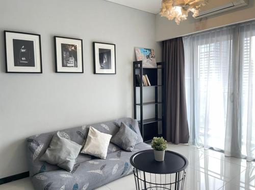 a living room with a couch and a table at Mercu Summer Suites Bernice KLCC in Kuala Lumpur