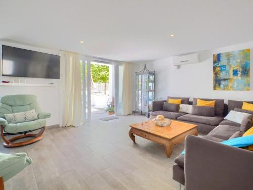 a living room with a couch and a table at Stylish Beach House in La Cala de Mijas 5 star location few steps from Butibamba Beach in La Cala de Mijas