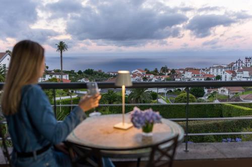 a woman taking a picture of the view from her balcony at The Lince Nordeste in Nordeste