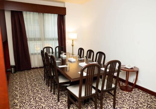 a conference room with a table and chairs in it at MRA Grand Hotel in Dubai