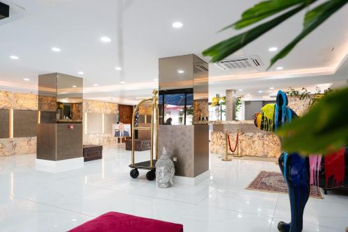 a lobby with a dressing room with a mirror at Hôtel Amazonia Cayenne Centre in Cayenne