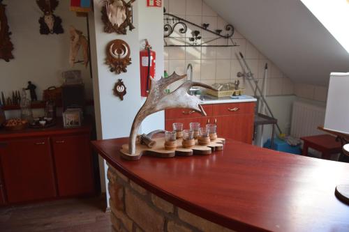 a table with a tree sculpture on top of it at Holló és Bárány Vendégház in Herend