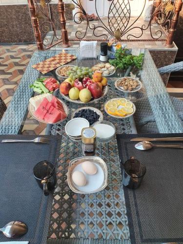 a table with plates of food on top at Hotel Jasmina in Samarkand