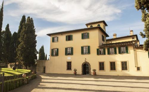 a large white house with a driveway at Art Hotel Villa Agape - Place of Charme in Florence