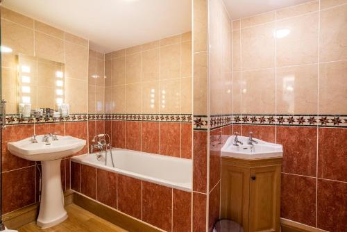 a bathroom with a tub and a sink and a bath tub at The Town House Ludlow in Ludlow