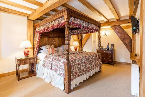 a bedroom with a canopy bed in a room at The Town House Ludlow in Ludlow