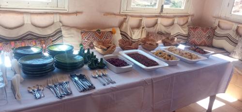 a table with several dishes of food on it at Maison d'Hôtes Irocha in Tisselday