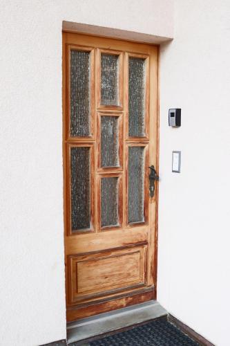 a wooden door with glass windows on a building at Chalet La Pala avec SPA in Val dʼIlliez