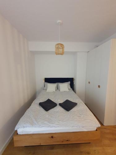 a bedroom with a bed with two pillows on it at LEOmare in Międzywodzie