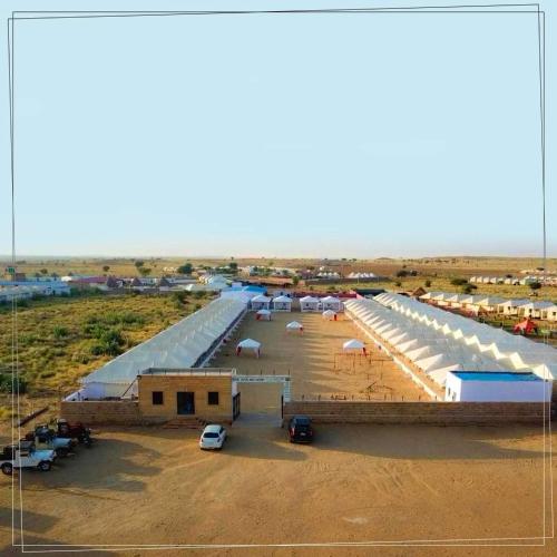 an aerial view of a parking lot with many tents at Marina Dessert Camp in Sām