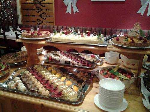 a buffet with many different types of food on a table at Le Souleil'Or in Les Deux Alpes
