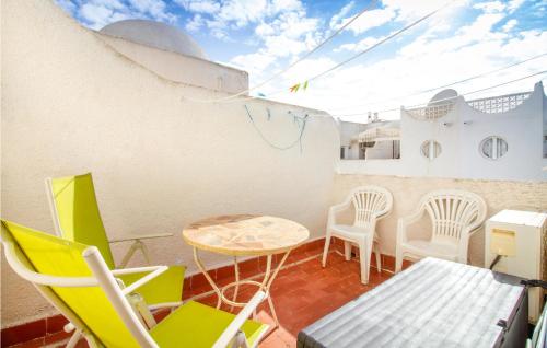 a small balcony with chairs and a table at 3 Bedroom Gorgeous Home In El Campello in El Campello