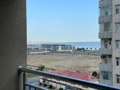 a view of the beach from a balcony of a building at Park Azure Modern apartment in Baku