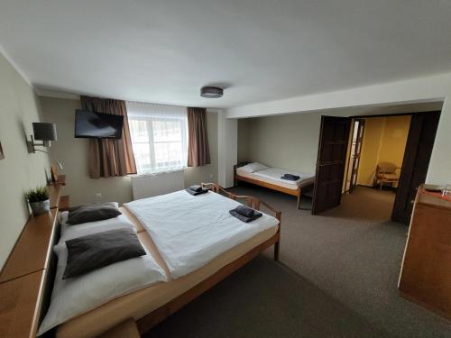a bedroom with a large bed in a room at Hotel STARÝ MLÝN in Jeseník