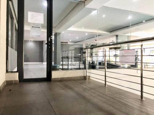 an empty room with glass doors in a building at Meridian Suite Apartments in Umhlanga Ridge in Durban