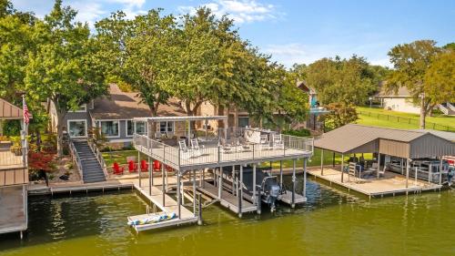 a dock on the water with a house at Waterfront House with Amazing Outdoor Oasis Boat Slip and Pet Friendly in Kingsland