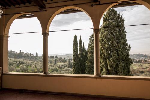 a window in a building looking out at trees at Art Hotel Villa Agape - Place of Charme in Florence
