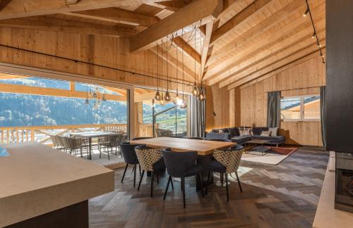 a dining room with a table and chairs at Apartmentresort MyLodge in Schladming