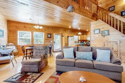 a living room with a couch and a table at Toccoa River Retreat in Suches