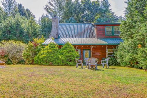 a house with a yard with chairs in front of it at Toccoa River Retreat in Suches