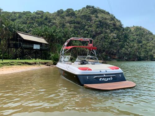 a boat sitting in the water on a river at Umtamvuna River Lodge in Port Edward