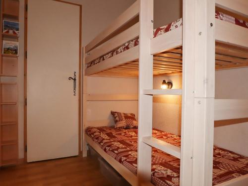 a bedroom with two bunk beds and a mirror at Appartement Samoëns, 2 pièces, 6 personnes - FR-1-624-117 in Samoëns