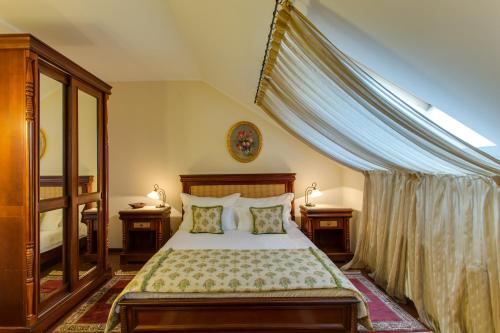 a bedroom with a bed with two pillows at Vila Paris Boutique Hotel in Bucharest