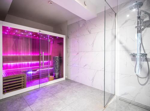 a bathroom with a shower with purple lighting at Apartos Wisus - Luxury Apartments in Świnoujście