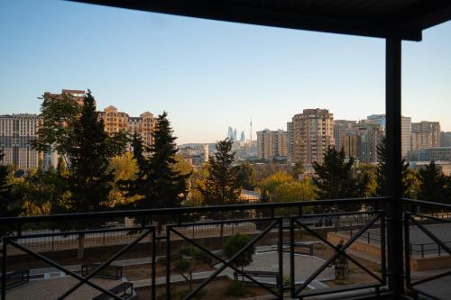 a view of a city from a balcony at The Clocktower Hotel in Baku