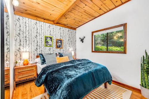 a bedroom with a bed and a window at Tree Tops Bungalow in Guerneville