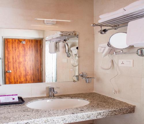 a bathroom with a sink and a mirror at Yashshree Kanishka in Gangtok