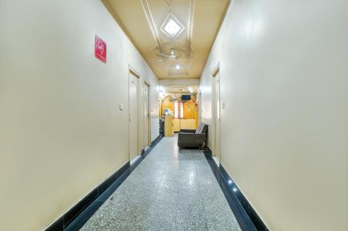 a hallway of a hospital with a chair in it at Hotel Surya in Ludhiana