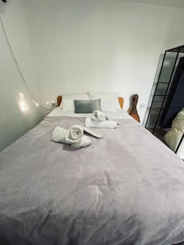 a bedroom with a large bed with towels on it at Yogo Place in Nahariyya in Nahariyya