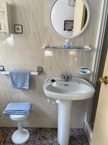 a bathroom with a white sink and a mirror at Hotel Arce in San Pedro del Pinatar