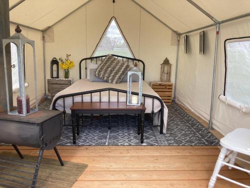 a bedroom with a bed in a tent at Tentrr Signature - Hidden Acres Orchards in Mead