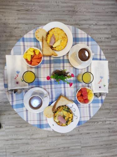 a table with plates of food on a table at Hotel Boutique Quinta Camacho in Bogotá