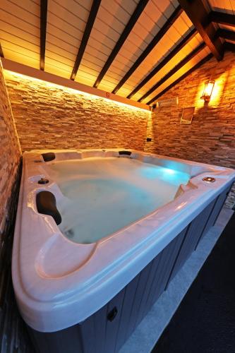 a large white bath tub in a room at Potter's Place by Ardenne Places in Theux